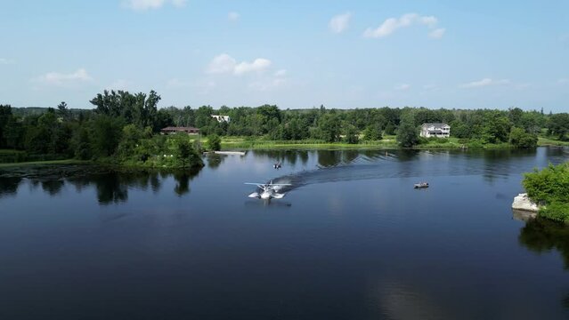 Seaplane Driving and Taking off on River Lake on Sunny Summer Day