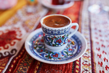 Turkish coffee served served in colorful decorated cup in cafe or restaurant in Istanbul, Turkey