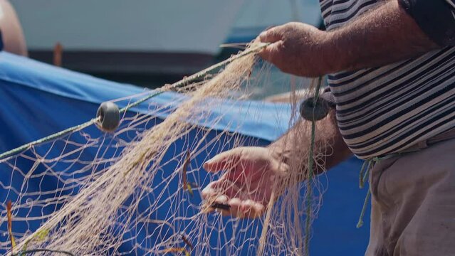 Hands Work Of Elderly Fisherman Repairing Their Nets Footage.