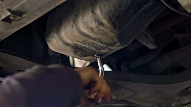 Opening the Crankcase Oil Plug and Draining the Old Worn Black Oil Footage.