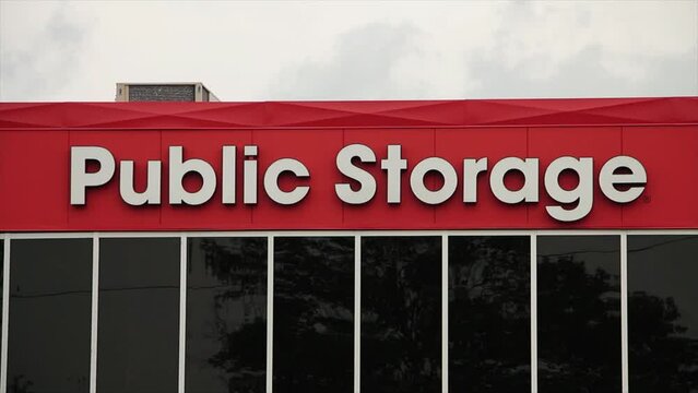 storage building public storage in white writing on orange background with dark windows, close shot top of frame