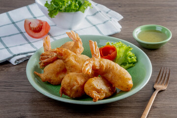 Battered fried prawns on wooden table