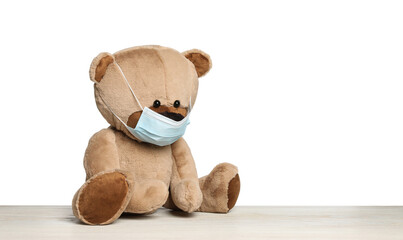 Cute teddy bear in medical mask isolated on white