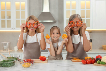Three generations. Happy grandmother, her daughter and granddaughter having fun while cooking...