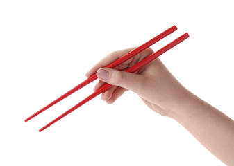 Woman holding pair of red chopsticks on white background, closeup