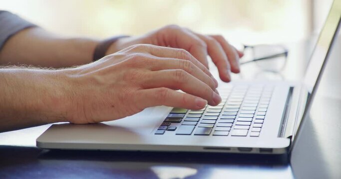 Closeup, hands typing on keyboard and writing recruitment email or worker online and on laptop. Working, remote office and browsing the internet or man search for new website or job on pc and desk