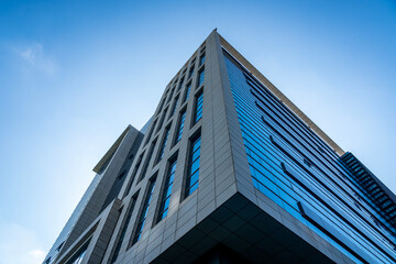 Fototapeta na wymiar Looking up at a modern city office building