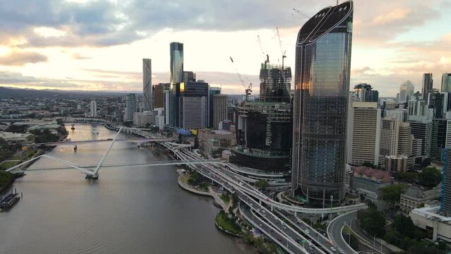Aerial drone view of Brisbane City, QLD, Australia showing the west facing side of the city along Brisbane River and Riverside Expressway and Neville Bonner Bridge during late afternoon in August 2023