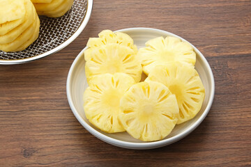 Fresh slices pineapple served in white plate
