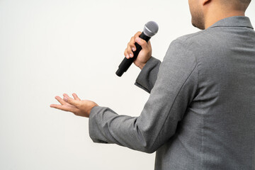 Close up businessman speaker hand holding High quality dynamic microphone and singing song or speaking talking with people on isolated white background. Male testing microphone voice for interview