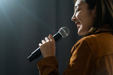 Close up woman hand holding High quality dynamic microphone and singing song or speaking talking...