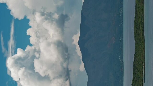 Huge clouds form and dissipate over Mont Dore, Grande Terre in New Caledonia - vertical time lapse