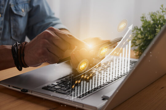 Casual Businessman Touch Mobile Phone and 2023 Stock Market Bar Chart or Graph Trend