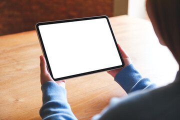 Mockup image of a woman holding digital tablet with blank white desktop screen