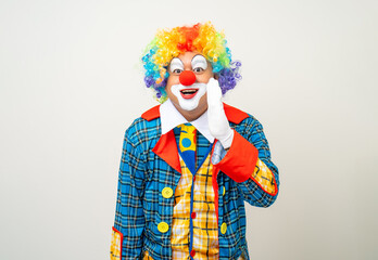 Fototapeta na wymiar Mr Clown. Funny shocked face comedian Clown man in colorful costume wearing wig shout out loud wow with hands on mouth announcement. Happy expression amazed bozo in various pose on isolated.