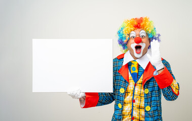 Mr Clown. Portrait of Funny face Clown man in colorful uniform standing holding copy space. Happy...
