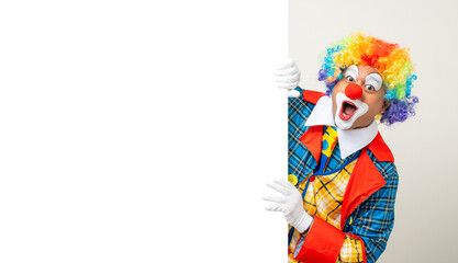 Mr Clown. Portrait of Funny face Clown man in colorful uniform standing holding copy space. Happy...