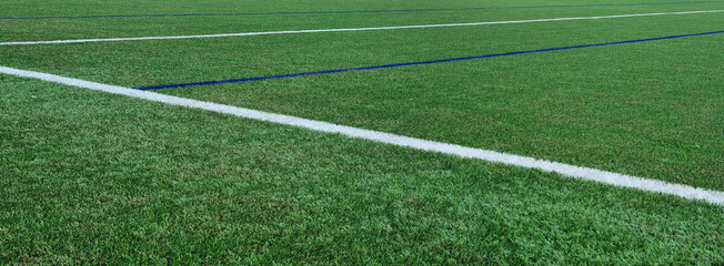Fototapeta na wymiar Soccer field texture panoramic background. synthetic grass football pitch empty wide banner with copy space for design
