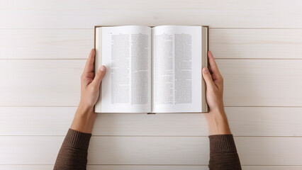 A man holding a book on the light table