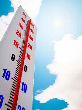 Outdoor thermometer close-up against the sky shows high air temperature.