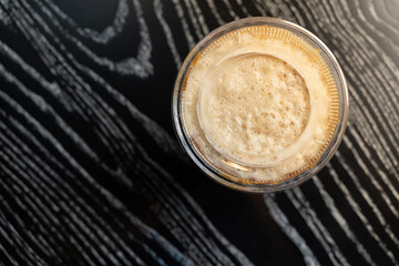 A top down view of a coffee drink. Coffee cup top view on old wooden