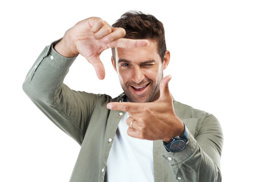 Man, portrait and hands frame for photography, profile picture and winking on isolated, transparent and png background. Face, smile and happy creative photographer with perspective fingers in border