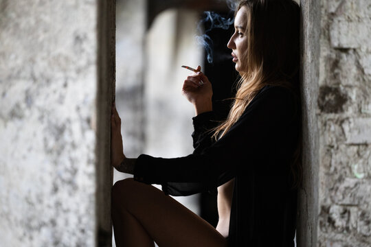 Portrait of a smoking girl on a blurred background