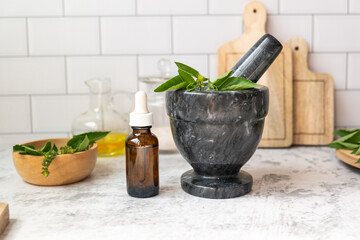 amber glass bottle mock up with herb medicine in pestle and mortar.