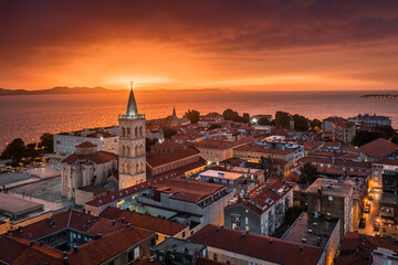 Zadar, Croatia - Aerial view of the tower of Cathedral of St. Anastasia and the old town of Zadar with a dramatic golden summer sunset