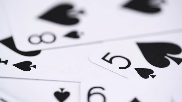 close up rotation of playing cards. soft focus. poker cards rotating pattern macro texture background. recreation and entertainment.
