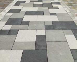 Pavement made of black, white and gray concrete tiles for outdoors. Background and texture. - Powered by Adobe