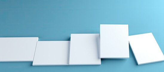 White Business Cards With Copy Space On Blue Background. Digital image showing a business card design on a blue background, with empty space for writing and stationery.