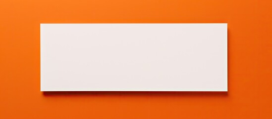 a white business card with copy space on an orange background, suitable for business purposes or stationery.