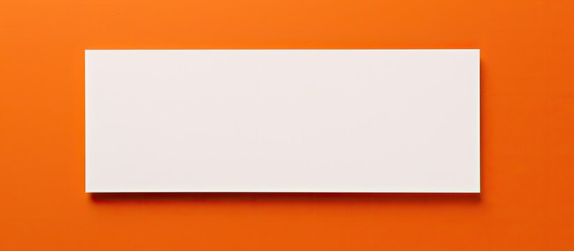 a white business card with copy space on an orange background, suitable for business purposes or stationery.