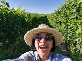 Selfie woman travel in vinyards, Okanagan valley, British Columbia Canada.