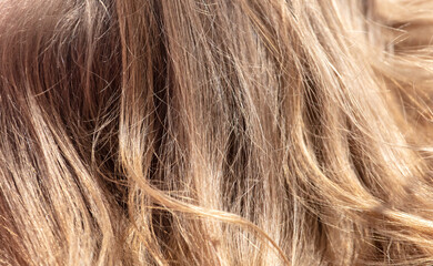 Blond female hair as an abstract background. Texture