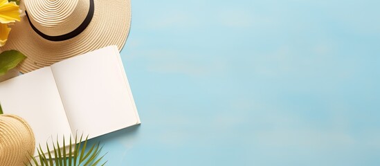 A writing book with summer beach accessories on the background, providing copy space. The arrangement is presented in a flat lay style with space for writing.