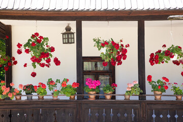 Fototapeta na wymiar A porch with flowers at an old traditional house
