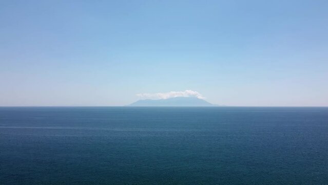 Aerial view of Samothraki island on Thracian Sea from Alexandroupoli, East Macedonia and Thrace, Greece. Flying above water with Samothraki island in the background with a cloud above it