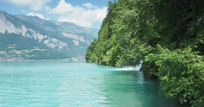Majestic blue-green waters of the lake Brienz (Canton Bern)  with view on Giessbach cascade brooking into the lake seen from Giessbach landing stage