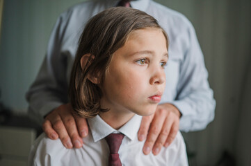 Contemplative son with father at home