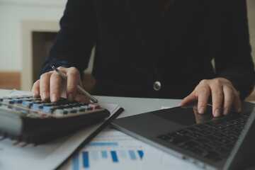 Unrecognizable businessman using calculator