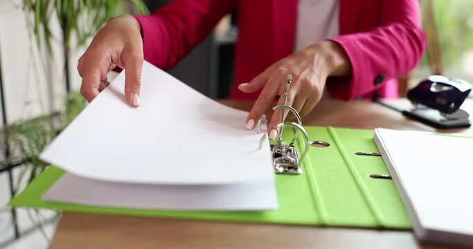 Woman with folder of documents at workplace in office. Documentation and archive of documents