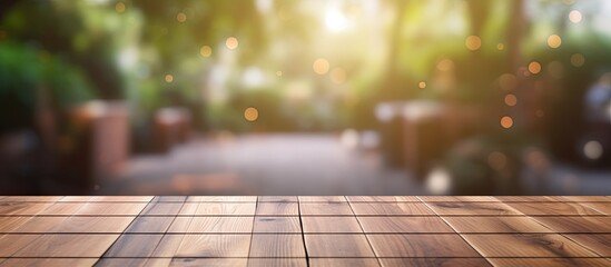 empty wooden table with a blurred outdoor garden as a backdrop for marketing promotions. The table offers ample space for text and advertisements.