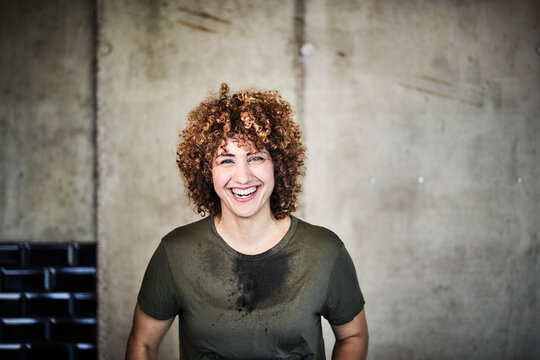 Portrait of laughing woman with stained T-shirt