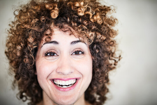 Portrait of sweating laughing woman with curly hair