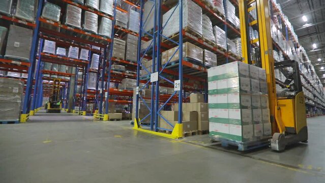 Warehouse work. Modern loaders in a large warehouse. Workflow in a large warehouse. Special equipment in the warehouse of the factory.