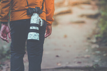 The man stand back camera. And carrying camera. isolated