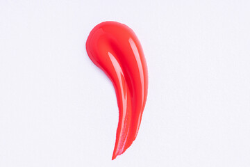 Deep red swatch of lip gloss, cosmetic product stroke or paint, macro. Swatches of red lipgloss or...