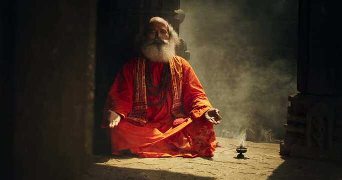 Authentic Shot of An Indian Senior Monk Practicing Yoga In A Temple Setting. Serene And Meditative Display Of Ancient Spiritual Practice, Seeking Profound Sense of Inner Peace and Enlightenment